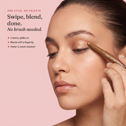 Model gliding the Pearl Golden Brown eyeshadow stick across her lid