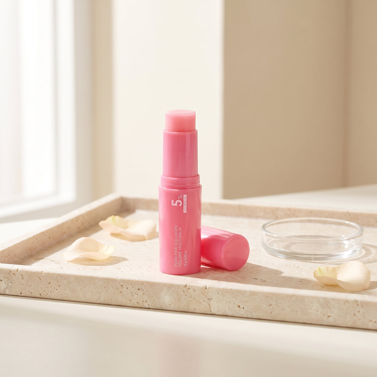 PDRN Pink Collagen Multi Balm stick on a stone tray